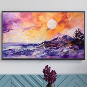 Könnte beinhalten: Ein gerahmtes Landschaftsgemälde zeigt einen Sonnenuntergang mit einem weißen Mond, lila Bergen und einem farbenfrohen Himmel. Das Kunstwerk hängt über einem blauen Schrank. Das Gemälde ist groß.