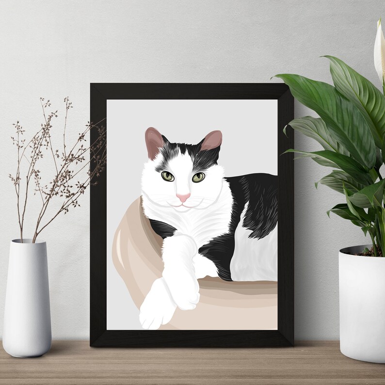 May include: A black and white cat with green eyes is lying in a beige cat bed. The cat is looking directly at the viewer.