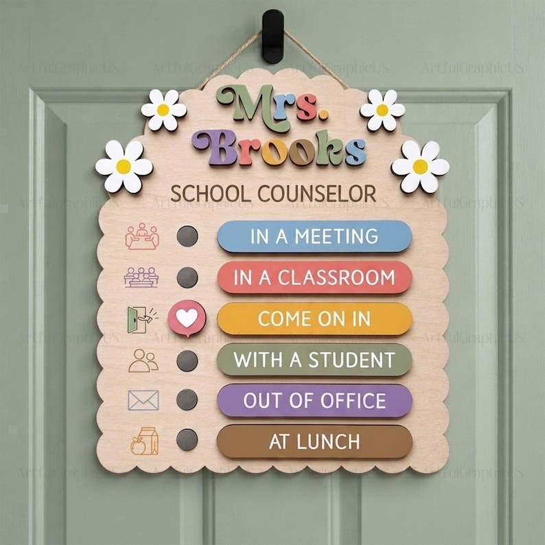 May include: A scalloped wooden door sign for a school counselor named Mrs. Brooks. It features a sliding heart indicator next to status options: In a Meeting, In a Classroom, Come On In, With a Student, Out of Office, and At Lunch, with floral accents.