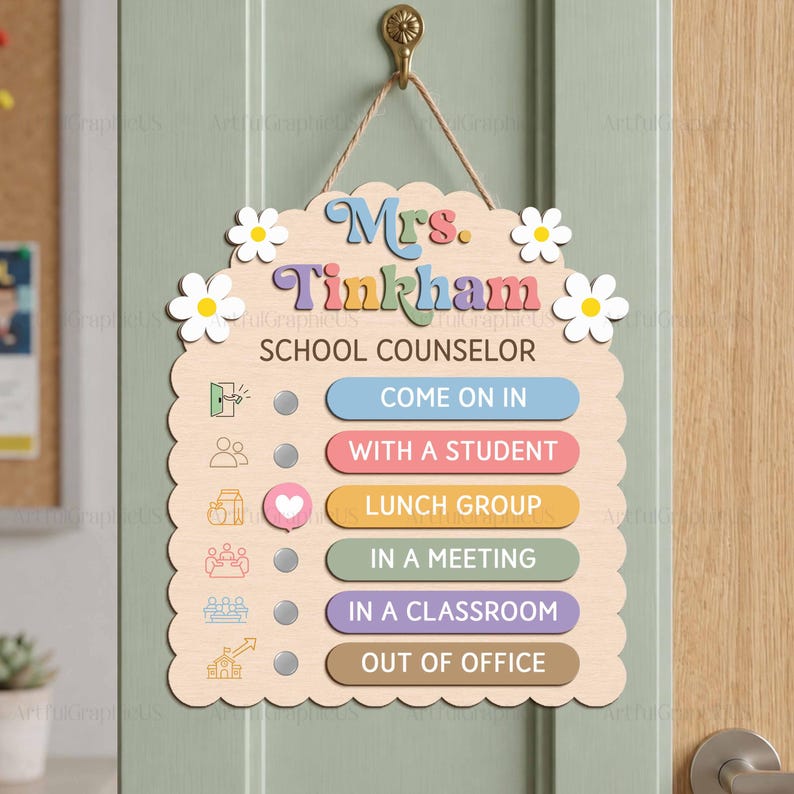 May include: A light wood scalloped sign hanging by a rope, featuring the text Mrs. Tinkham SCHOOL COUNSELOR and white daisy accents. It includes six status options with icons: COME ON IN, WITH A STUDENT, LUNCH GROUP, IN A MEETING, IN A CLASSROOM, and OUT OF OFFICE.
