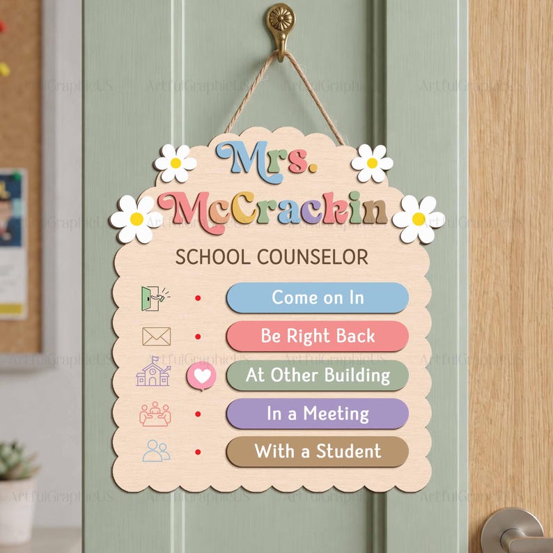 May include: A light wood hanging sign with scalloped edges and white daisy accents. It features the text Mrs. McCrackin School Counselor and five status options: Come on In, Be Right Back, At Other Building, In a Meeting, and With a Student.