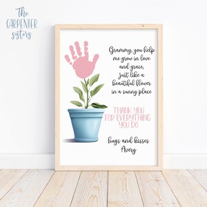 May include: A printable art print with a pink handprint in the shape of a flower growing in a blue pot. The text reads "Grammy, you help me grow in love and grace, just like a beautiful flower in a sunny place. Thank you for everything you do. Hugs and kisses, Avery."