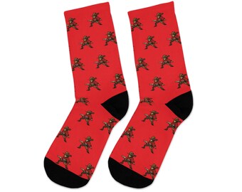 May include: A pair of red socks with a repeating pattern of a cartoon character wearing a cowboy hat and holding a gun. The socks are black at the toes and heels.