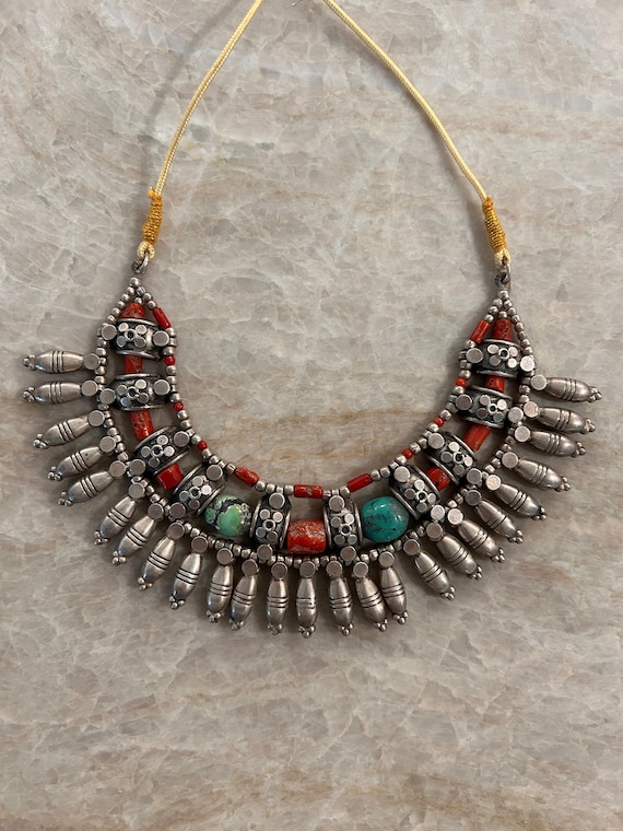 Tribal necklace with turquoise and coral beads.