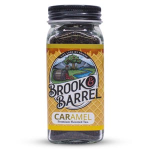May include: A glass jar of Brook & Barrel Caramel Premium Flavored Tea. The jar has a black lid and a label with a landscape scene and the words "Live Long My Friend." The label also says "Brook & Barrel" and "Caramel."