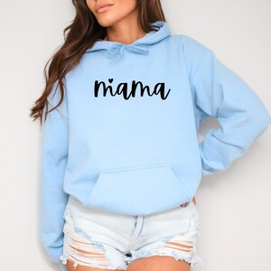 May include: A light blue hoodie with a black cursive text that says "mama" with a small heart above the "m".
