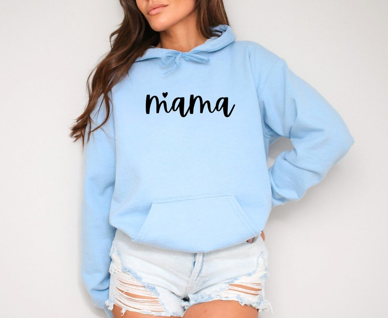 May include: A light blue hoodie with a black cursive text that says "mama" with a small heart above the "m".