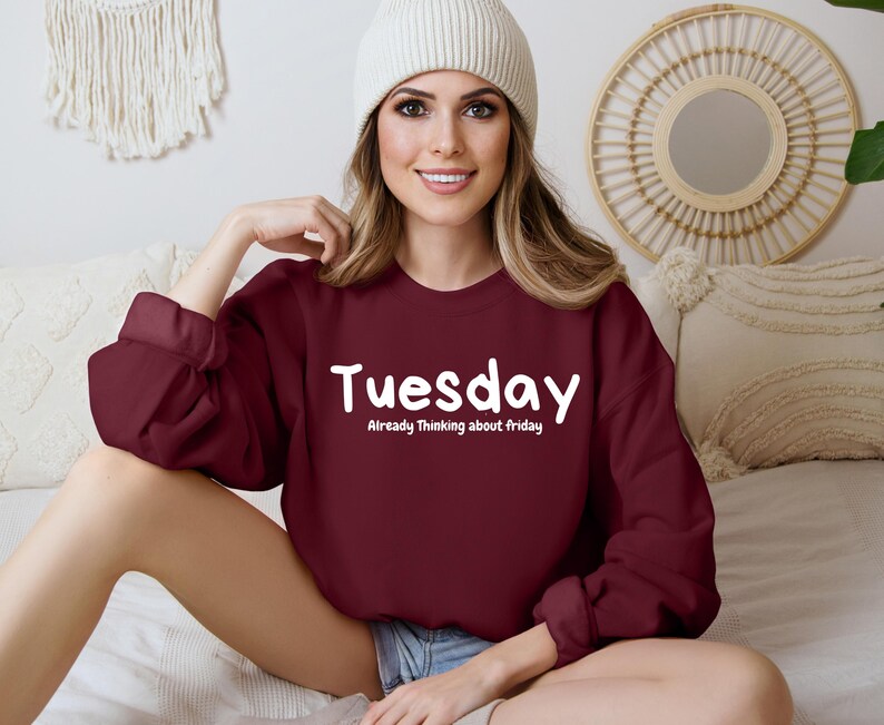 May include: A maroon sweatshirt with the text "Tuesday" and "Already Thinking about Friday" in white lettering.