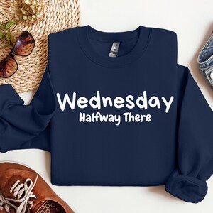 May include: A navy blue sweatshirt with white text that reads "Wednesday Halfway There".