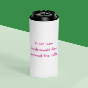 May include: White can cooler with a pink inscription that reads "A hot new bridesmaid has entered the villa".