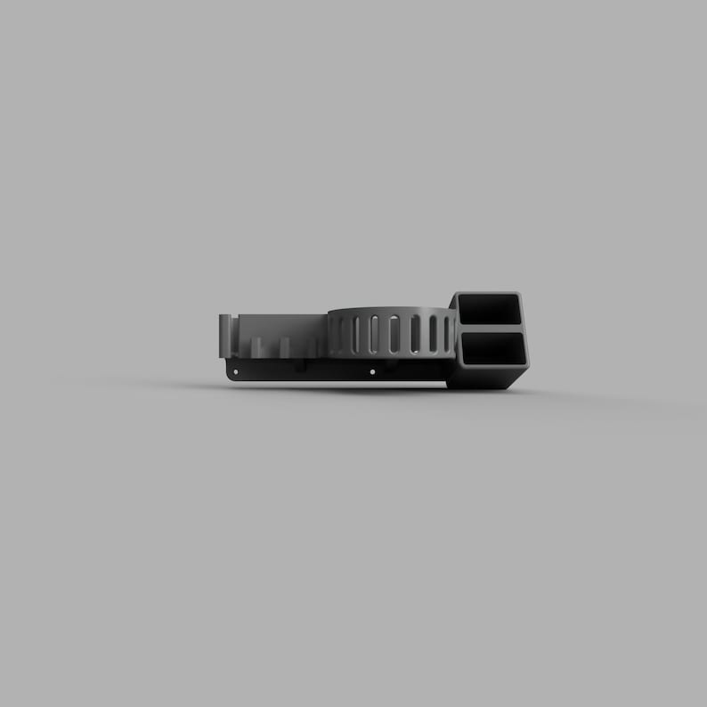 May include: A grey wall-mounted organiser with a circular rack and a rectangular compartment with two slots. The organiser is made of plastic and has a modern design.