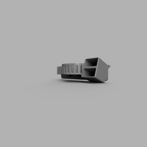 May include: A grey whistle with a round, ribbed mouthpiece and a rectangular chamber. The whistle has a small loop on the side for attaching a lanyard.