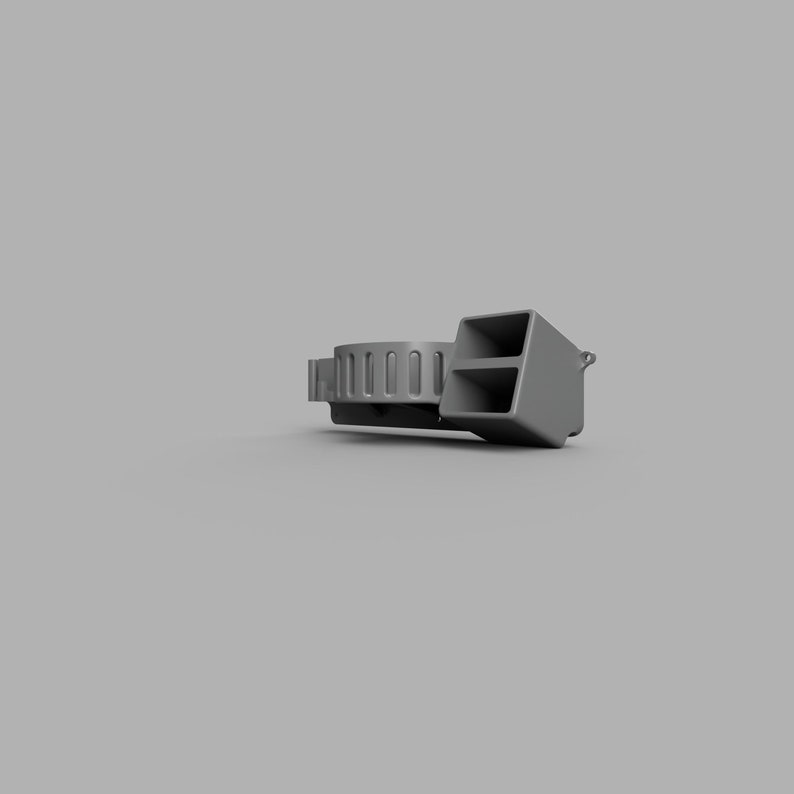 May include: A grey whistle with a round, ribbed mouthpiece and a rectangular chamber. The whistle has a small loop on the side for attaching a lanyard.