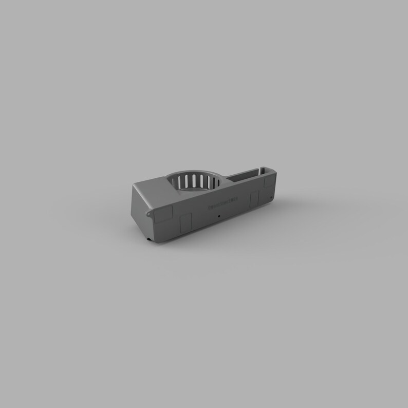 May include: Grey plastic phone holder with a circular opening and a slot for a charging cable. The holder has the word "remarkable" printed on it.