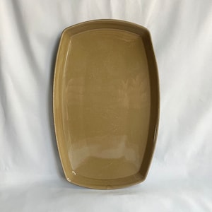May include: A large, rectangular, brown ceramic serving tray with a glossy finish.