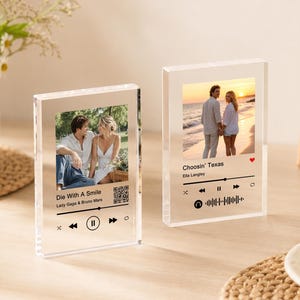 May include: Two clear rectangular acrylic blocks featuring custom photo prints and music player interface graphics. One block displays Die With A Smile by Lady Gaga and Bruno Mars with a QR code, while the other shows Choosin' Texas by Ella Langley.