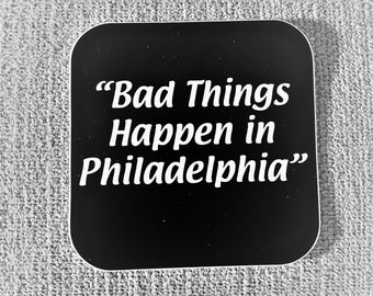 May include: Black square sticker with white text that reads "Bad Things Happen in Philadelphia".