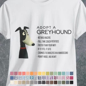 May include: A white t-shirt featuring a black and white illustration of a greyhound dog with a red collar. The text reads: ADOPT A GREYHOUND, RETIRED RACERS, FULL TIME COUCH POTATOES, FASTER THAN YOUR WIFI, IF IT FITS, IT SITS, ZOOMIES TO SNOOZIES IN A NANOSECOND, POINTY NOSE, BIG HEART.