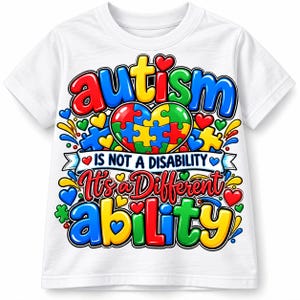 May include: A white short-sleeved t-shirt featuring a colorful graphic print. The design includes the text "autism IS NOT A DISABILITY It's a Different ability" in bold, multi-colored letters, surrounded by puzzle pieces and small hearts.