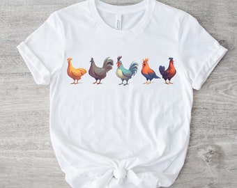 Puede incluir: Camiseta blanca con un gráfico de cinco pollos coloridos en fila.