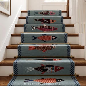 May include: Staircase runners with a repeating fish pattern. The runners are a muted teal color with a dark blue border and brass hardware. Each runner features a different fish design in shades of red, brown, and black.