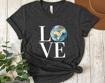 May include: Dark grey heather t-shirt with the word "LOVE" in white block letters. The "O" is replaced with a watercolor image of the Earth. The words "DARK GREY HEATHER" are printed in a small box at the bottom.