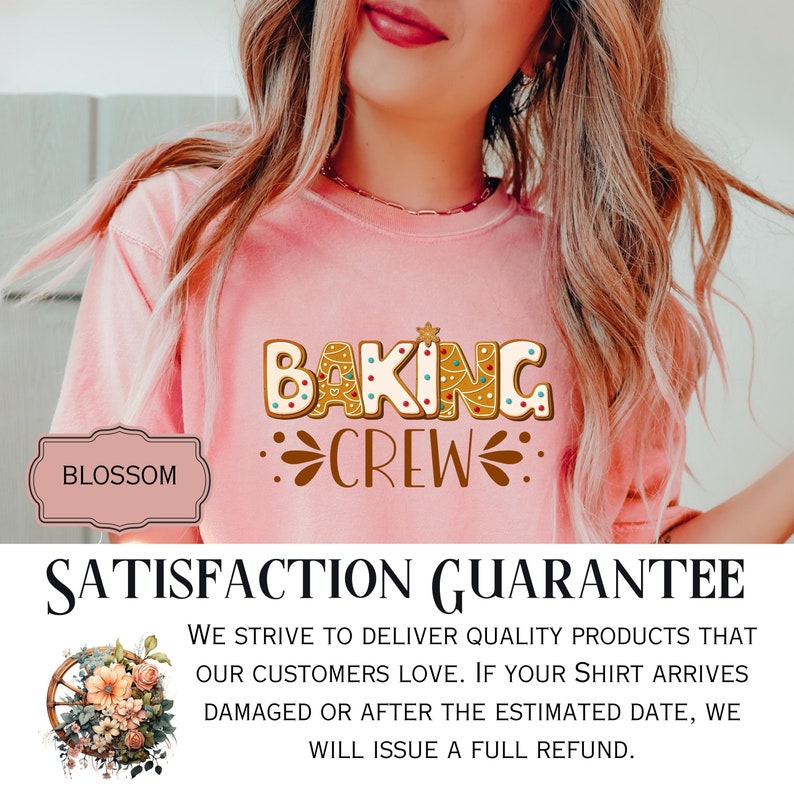 May include: A light pink short-sleeved t-shirt featuring a graphic design of gingerbread-style letters that spell out BAKING CREW. The letters are decorated with colorful dots and a small star. The text is brown and includes decorative flourishes.