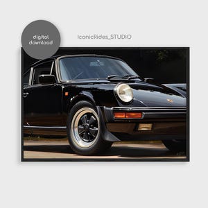 May include: A black Porsche 911 sports car with a black interior. The car is parked on a paved road with trees in the background. IconicRides_STUDIO is printed in the top right corner of the image.