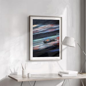 May include: Framed artwork depicting a Formula 1 race car in motion. The painting features a dark background with streaks of color, suggesting speed. The car is primarily black and orange, with a blurred effect.