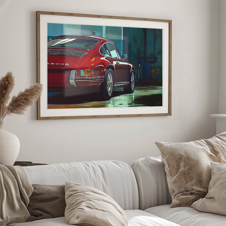 May include: A red Porsche 911 classic car parked in a garage. The car is facing away from the camera, and the rear of the car is in focus. The car has a black interior and a black license plate.