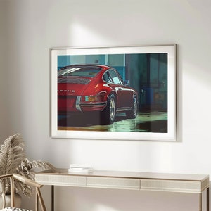 May include: A framed print of a red Porsche 911 driving out of a garage. The car is in focus, while the garage is blurred in the background.