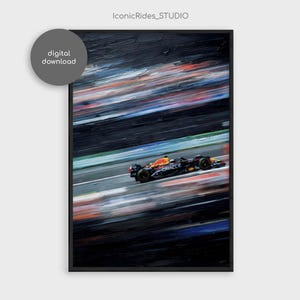 May include: Digital download art print of a Formula 1 race car in motion. The artwork features a black, red, and yellow race car speeding on a track, with blurred streaks of color in the background. The text "IconicRides_STUDIO" is visible.