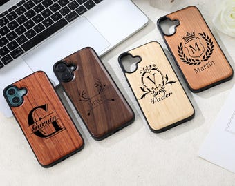 May include: Four wooden phone cases with black borders. Each case features a unique design: a letter "G" with "Garvin", antlers with "Bruce", a letter "V" with "Vader", and a crown with "Martin". The cases vary in wood tone.