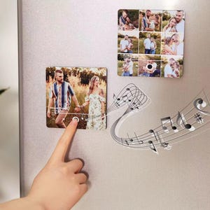 May include: Two rectangular photo magnets with images of a couple, one with a button being pressed. A second magnet displays a collage of family photos. Musical notes emanate from the first magnet. The magnets are on a silver surface.