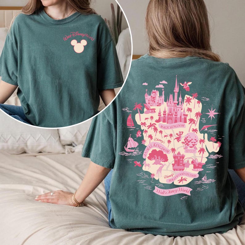 May include: Teal t-shirt with a pink graphic of the Walt Disney World map on the back. The front of the shirt has the words "Walt Disney World" and a Mickey Mouse head. The shirt is a relaxed fit.