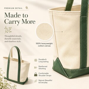 May include: Cream-colored tote bag with green accents. The bag is made of 100% heavyweight cotton canvas and features green handles and a green base. The text "Made to Carry More" is displayed on the image.