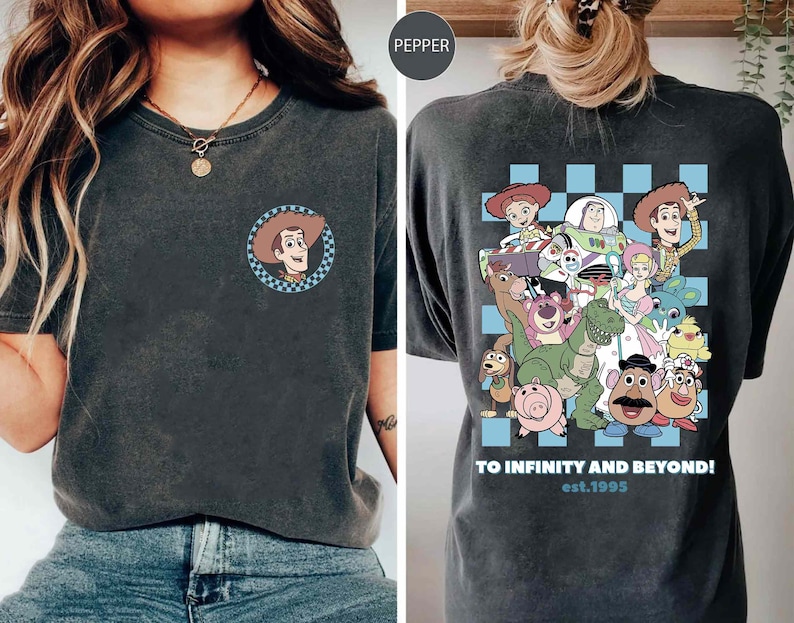 May include: A black t-shirt with a blue and white checkered pattern and a graphic of characters from the Toy Story movie franchise. The text "To Infinity and Beyond! est. 1995" is printed on the shirt.