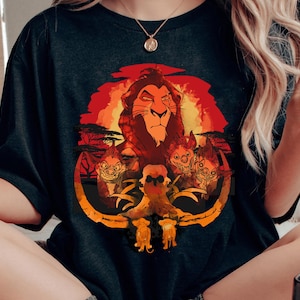 May include: Black t-shirt with a graphic print of Simba from The Lion King. The graphic features Simba with a sunset background and three hyenas.