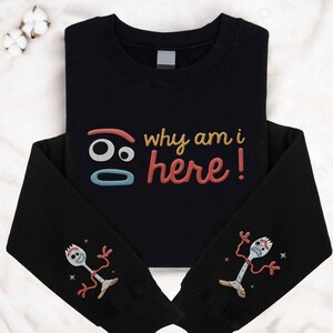 May include: Black sweatshirt with a red, yellow and blue embroidered design that says "Why am I here!" and a cartoon character with a fork for a head on each sleeve.