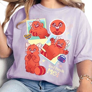 May include: Purple t-shirt with a graphic design featuring red pandas in different poses. The text "Red Panda Me" is printed on the shirt.