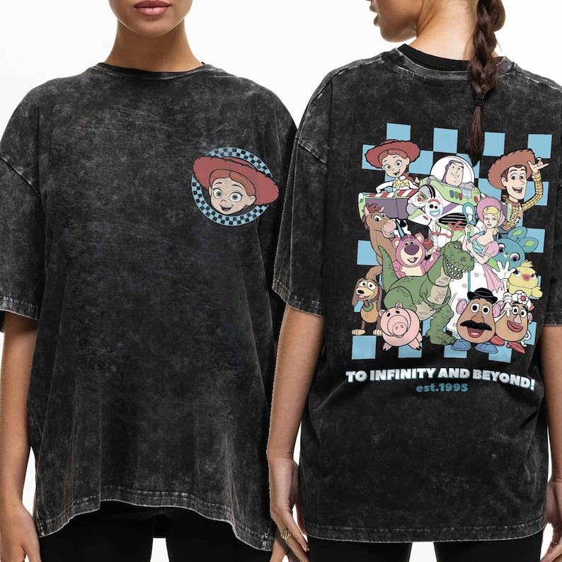 May include: Black t-shirt with a distressed look featuring a Toy Story character print on the front and back. The front features a close-up of Jessie, while the back features a group of Toy Story characters including Woody, Buzz Lightyear, and Rex. The back also includes the text "To Infinity and Beyond! est.1995".