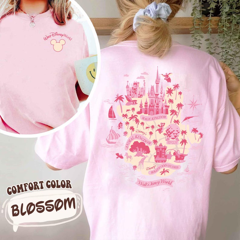 May include: Pink Comfort Color t-shirt with a Disney World graphic on the back. The front of the shirt has the words "Walt Disney World" and a Mickey Mouse head. The shirt is a light pink color and has the word "Blossom" on the bottom.
