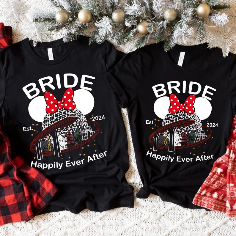 May include: Two black t-shirts with the word "BRIDE" in white, featuring a Minnie Mouse-inspired design with a red bow and a roller coaster graphic. The text "Happily Ever After" is below the design. The year "2024" is also printed on the shirts.