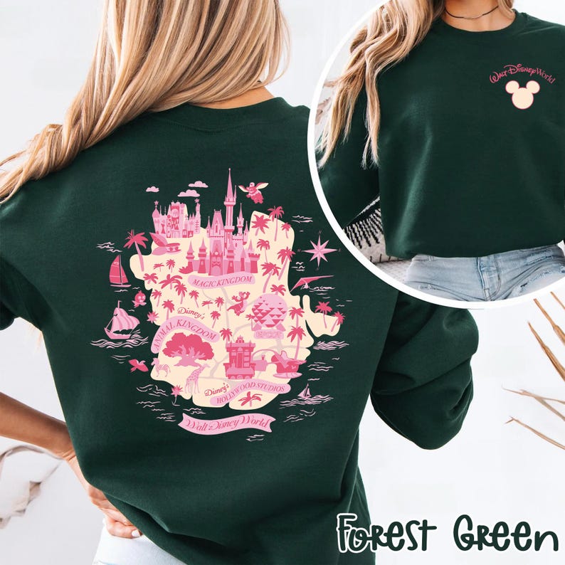 May include: Forest green sweatshirt featuring a pink map of Walt Disney World with park names. The back of the sweatshirt displays a detailed map of the park with illustrations of landmarks. The front has a small pink Mickey Mouse head and "Walt Disney World" text.