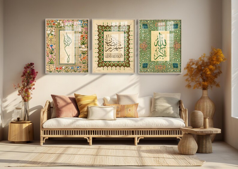 May include: Three framed Islamic calligraphy art pieces. The artwork features ornate floral and geometric patterns in shades of green, gold, and beige. The calligraphy is in black ink. The frames are white.