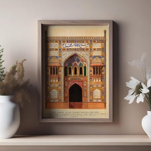 May include: A framed illustration of a colorful, ornate building with intricate details and Arabic script. The building has a large arched entrance and is surrounded by a decorative border. The text below the image reads "Main Entrance to the Old Moti Masjid, constructed about 1650, and considered to be the finest specimen of its class in Lahore, Baluchistan. Built by Shah Jahan, Emperor of Delhi, 1628-1658."