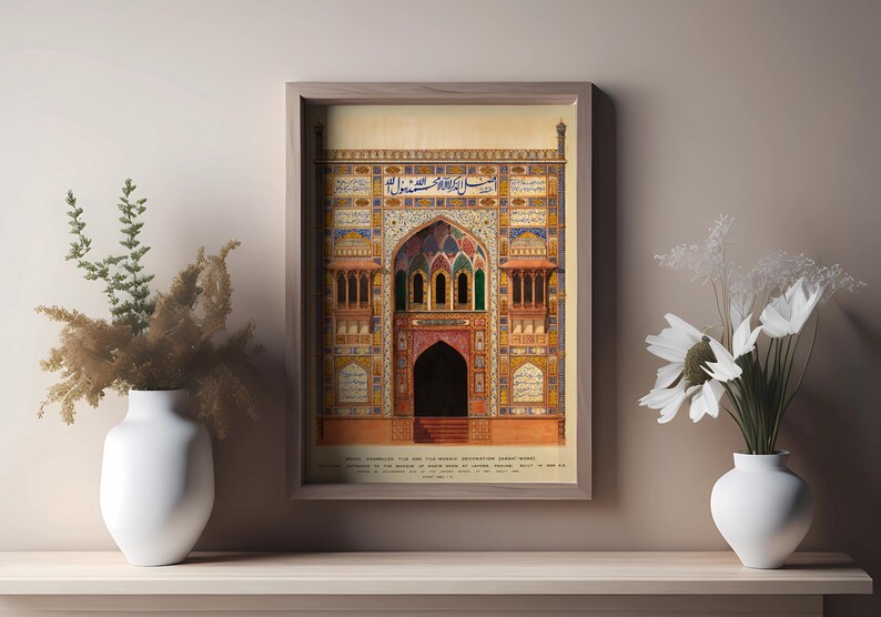 May include: A framed illustration of a colorful, ornate building with intricate details and Arabic script. The building has a large arched entrance and is surrounded by a decorative border. The text below the image reads "Main Entrance to the Old Moti Masjid, constructed about 1650, and considered to be the finest specimen of its class in Lahore, Baluchistan. Built by Shah Jahan, Emperor of Delhi, 1628-1658."