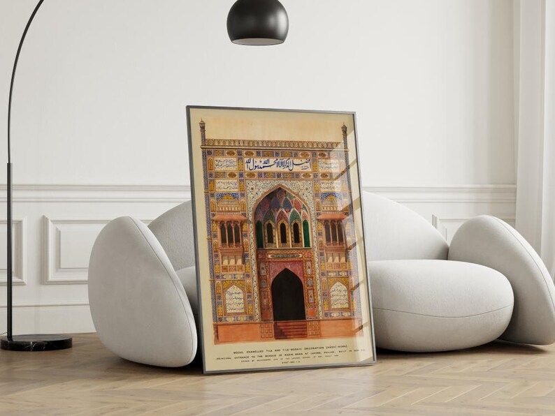 May include: A framed print of an intricate, colorful, and detailed illustration of an ornate archway with Arabic script. The archway is decorated with geometric patterns and floral motifs. The print is set against a white wall and a white couch.