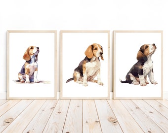 May include: Three framed watercolour paintings of beagle puppies. Each puppy is sitting and looking up. The frames are light wood.