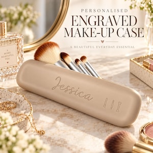 May include: A beige, elongated, cylindrical make-up case featuring the engraved name Jessica and three small brush icons. The case is open, holding four make-up brushes with brown and white bristles and silver ferrules, displayed on a surface.
